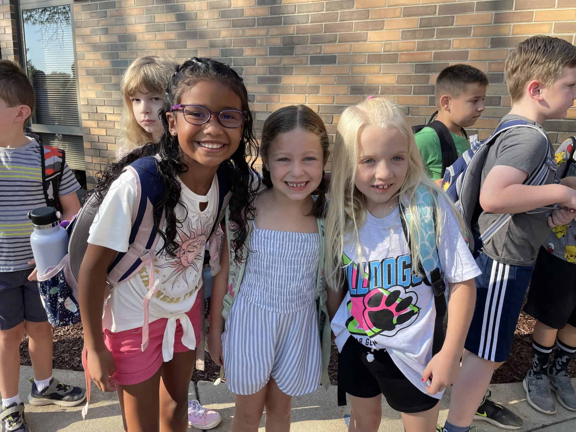 3 girl students outside of school